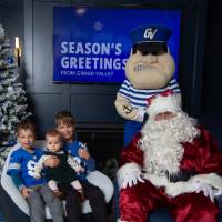 Two boys hold baby sister with Santa and Louie